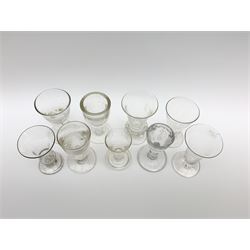 Group of 18th/19th century drinking glasses, to include a jelly glass with trumpet bowl, gadrooned collar and spreading circular foot, H11cm, firing glass with rounded funnel bowl with engraved and faceted border, upon a plain stem and thick firing foot, H9.5cm, further firing glass with the funnel bowl, upon a flanged firing foot, H8cm, etc. 