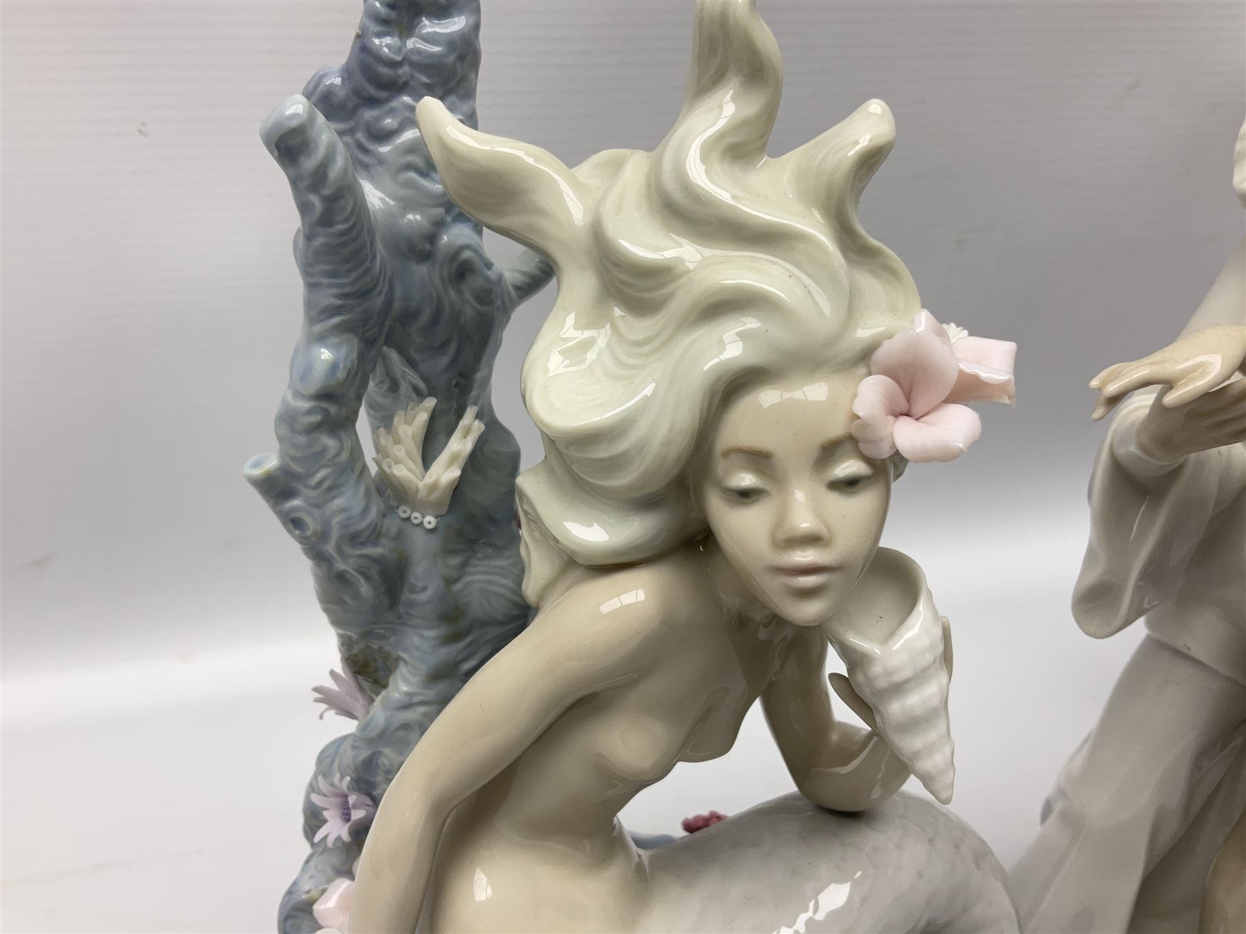 Four Lladro figures, comprising Touch of Class no 5377, Boy Student no 4517, Ocean Beauty no 5785 and Carnival Couple no 4882, largest example H45cm