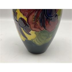 Moorcroft Hibiscus pattern vase of ovoid form, decorated with pink, yellow and purple flowers on merging blue and green vase, with impressed and painted marks beneath, H18cm