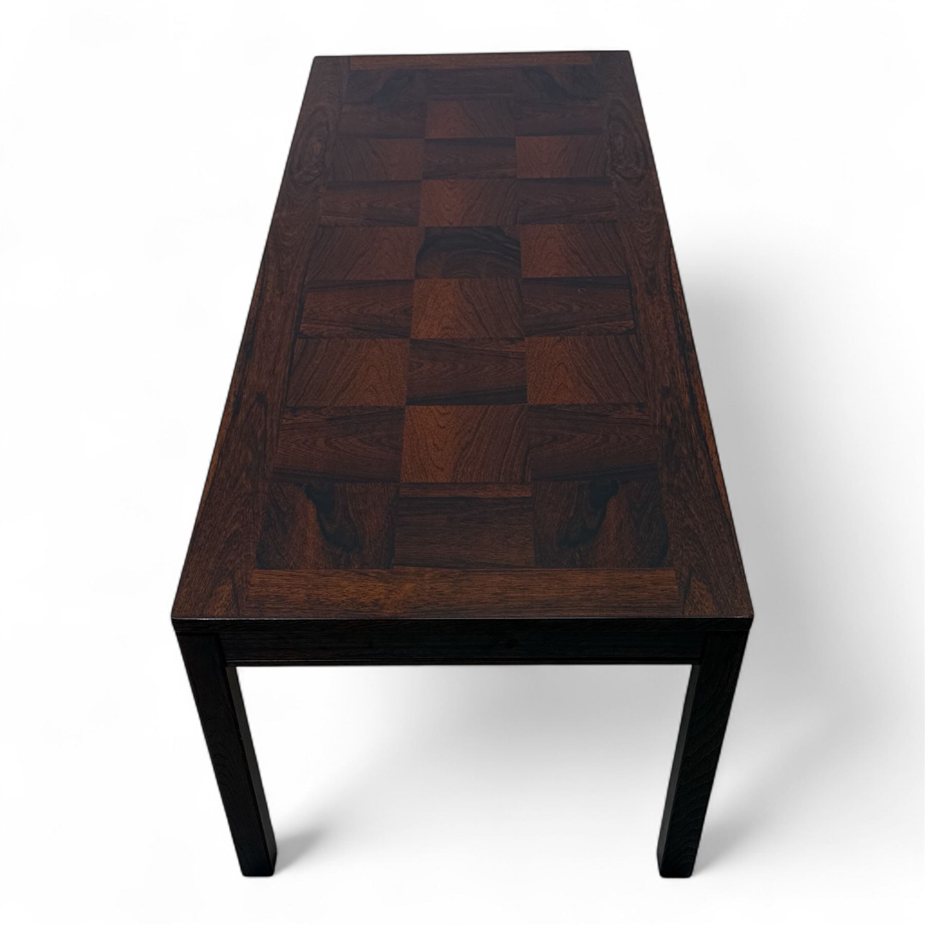 Heggen, Norway - 1970s parquetry veneered rosewood coffee table, the top with 'patchwork' parquetry design, raised on square-section supports