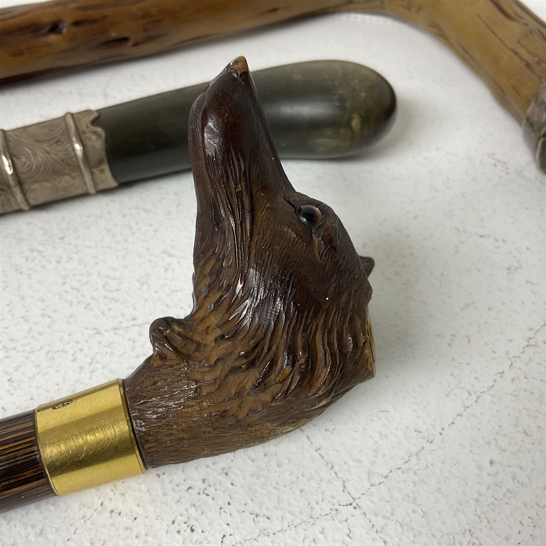 19th century painted bamboo walking cane, the handle carved as a fox with glass eyes, with gilt metal stamped LB, together with an ebonised wooden walking stick, with horn pommel and hallmarked silver collar and a curved wooden walking stick, with monogrammed white metal cap, tallest L90cm