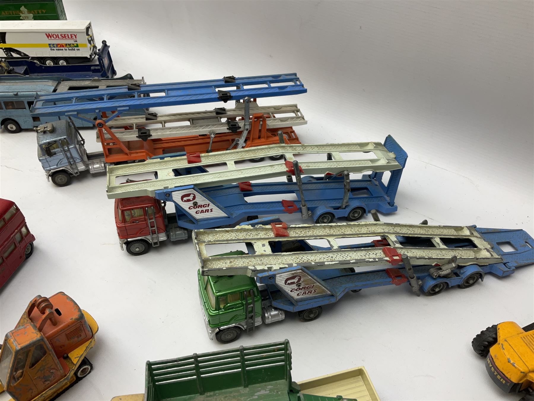 Corgi - eighteen unboxed and playworn/repainted die-cast commercial vehicles including Commer 5-Ton Wagon with drop-side trailer and two other 5-Ton wagons, Dodge Key Fargo, Jeep FC-150, two London Routemaster buses, Carrimore Trideck Transporter, two Carrimore Mark IV Transporters, Carrimore Low Loader, Ecurie Ecosse Racing Car Transporter etc (18)