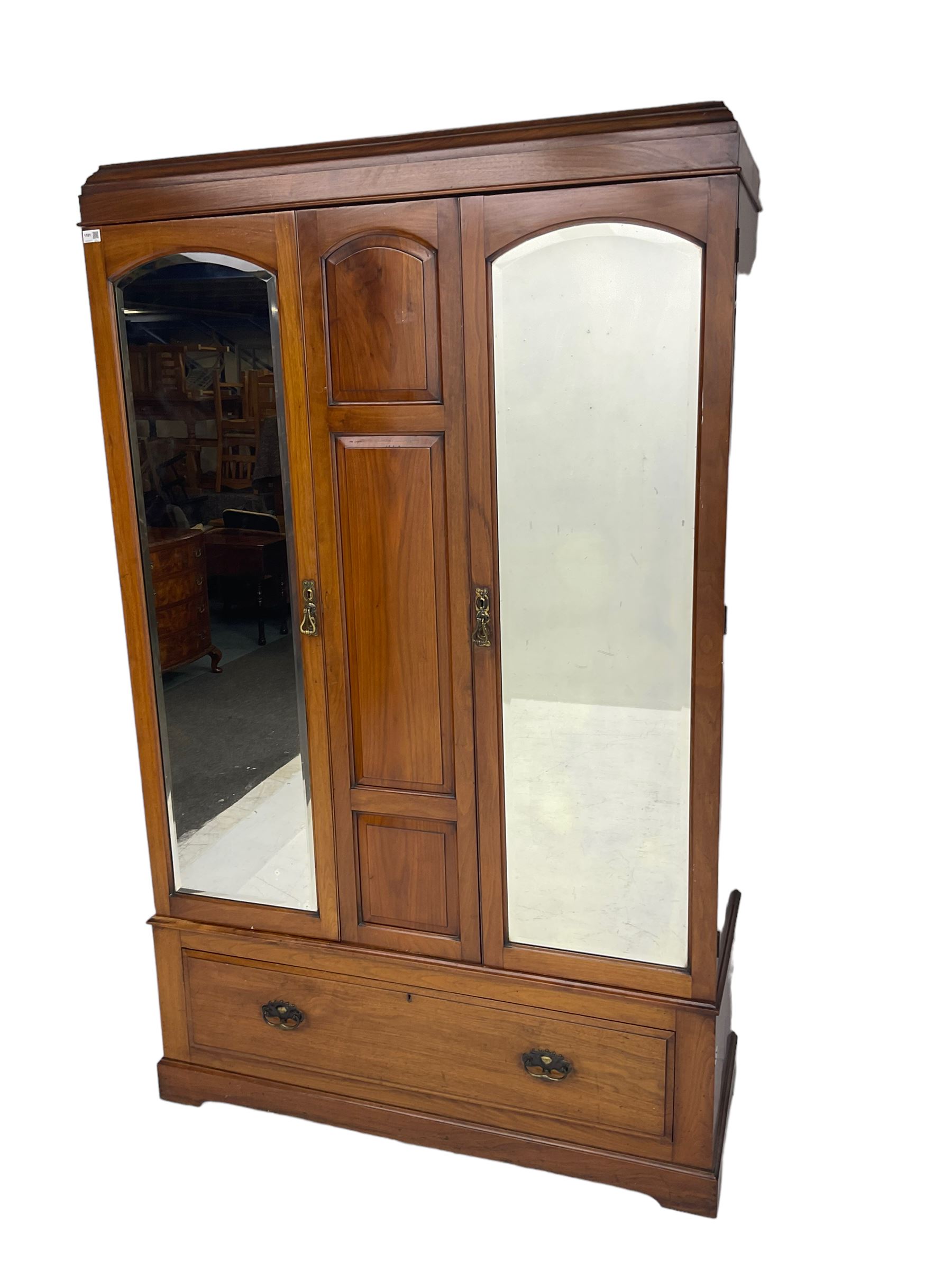 Edwardian walnut double wardrobe, fitted with two bevelled mirror panelled doors, single drawer to base