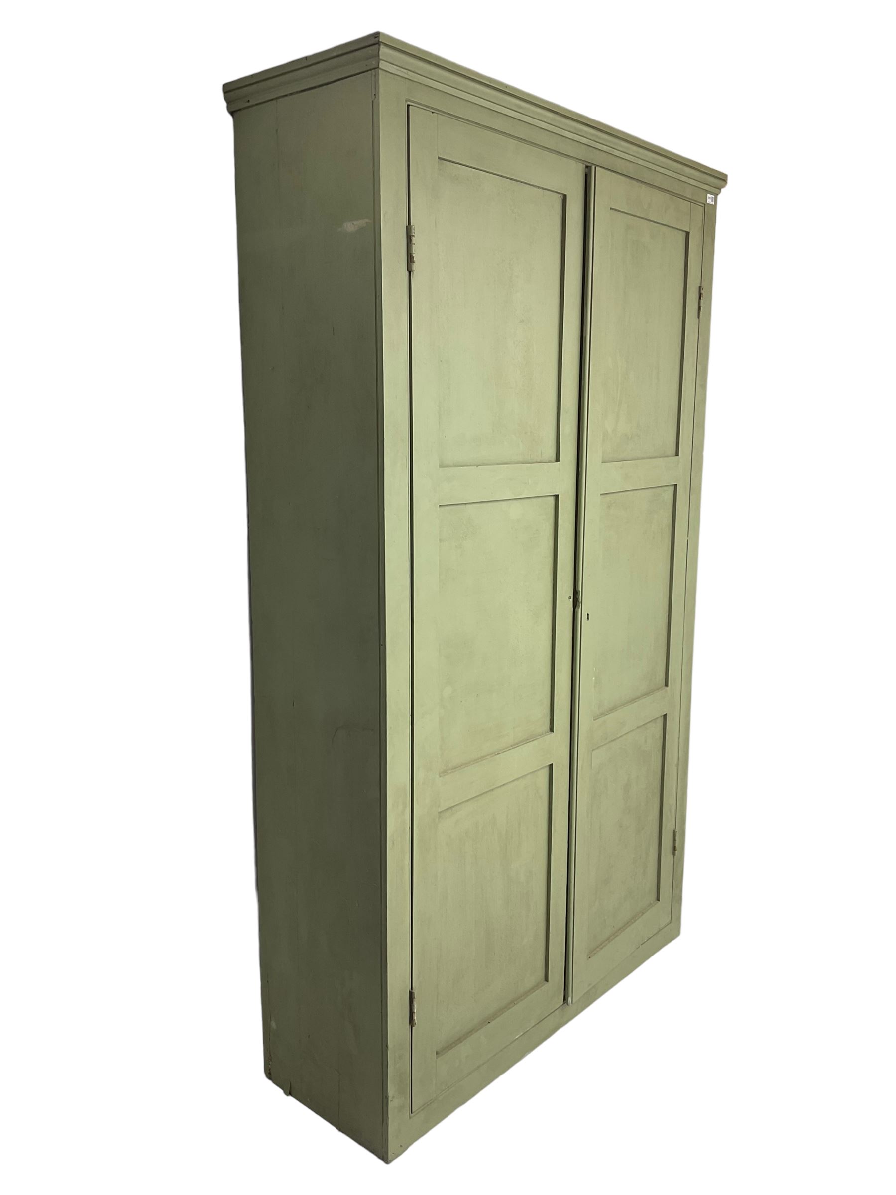 Painted pine cupboard, two panelled doors enclosing four shelves, in laurel green finish