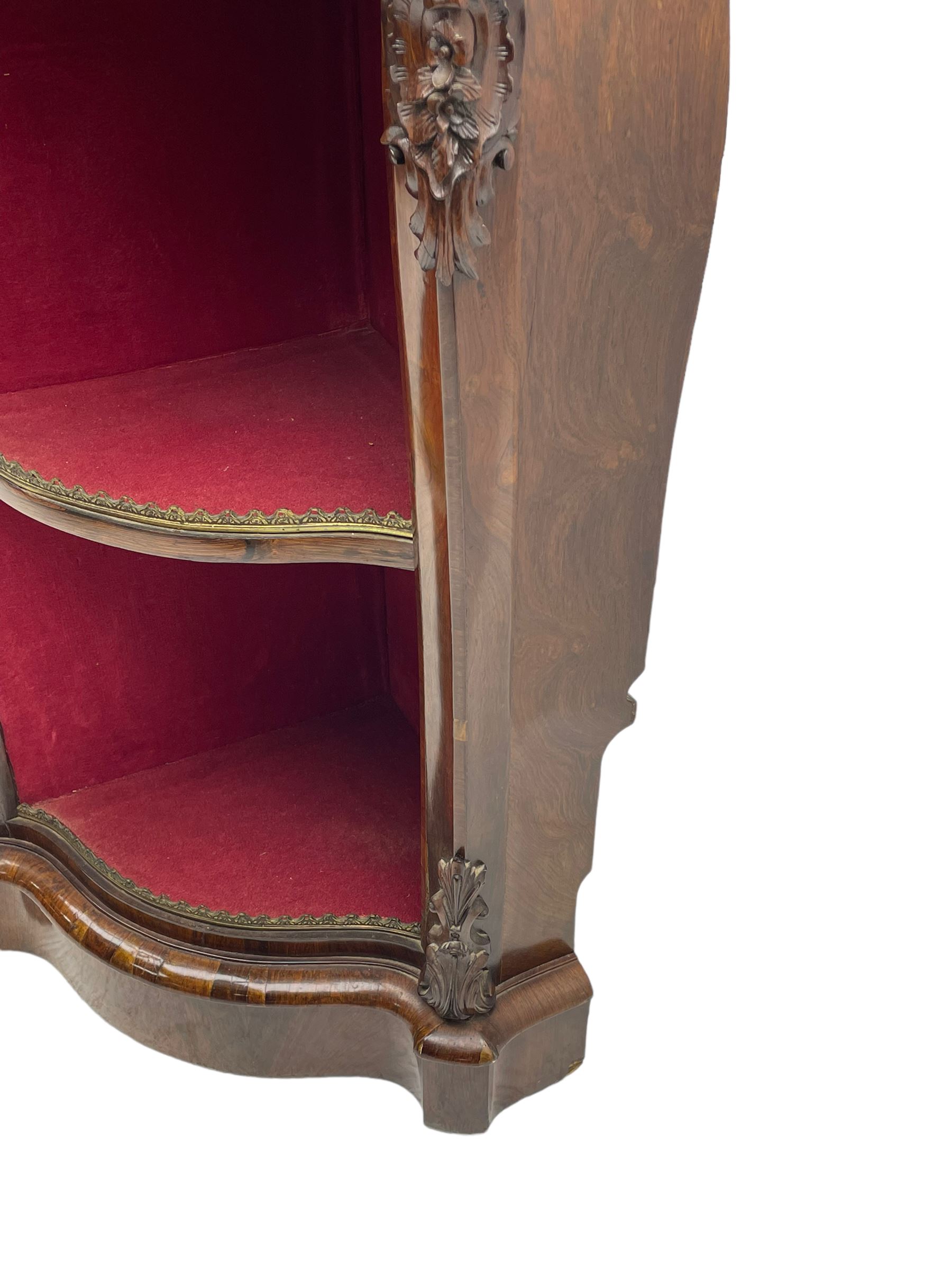 19th century rosewood buffet credenza, bombe form with shaped and moulded top, two central glazed doors with foliate moulded gilt slips, the red fabric-lined interior fitted with a single shelf, flanked by open shelves with raised gilt metal lips, the uprights decorated with shell and flower head carved cartouche mounts, acanthus leaf scroll carved lower mounts, on shaped and moulded plinth base 