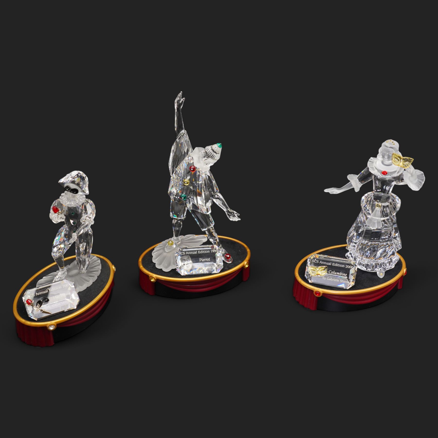 Swarovski crystal 'Masquerade' trilogy; 1999 Masquerade Pierrot, 2000 Columbine, 2001 Harlequin all with accompanying plaque, stand and original box
