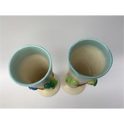 A pair of Clarice Cliff Newport Pottery vases, of tall ribbed conical form decorated in relief with two budgerigars, with printed marks beneath, H31.5cm. 