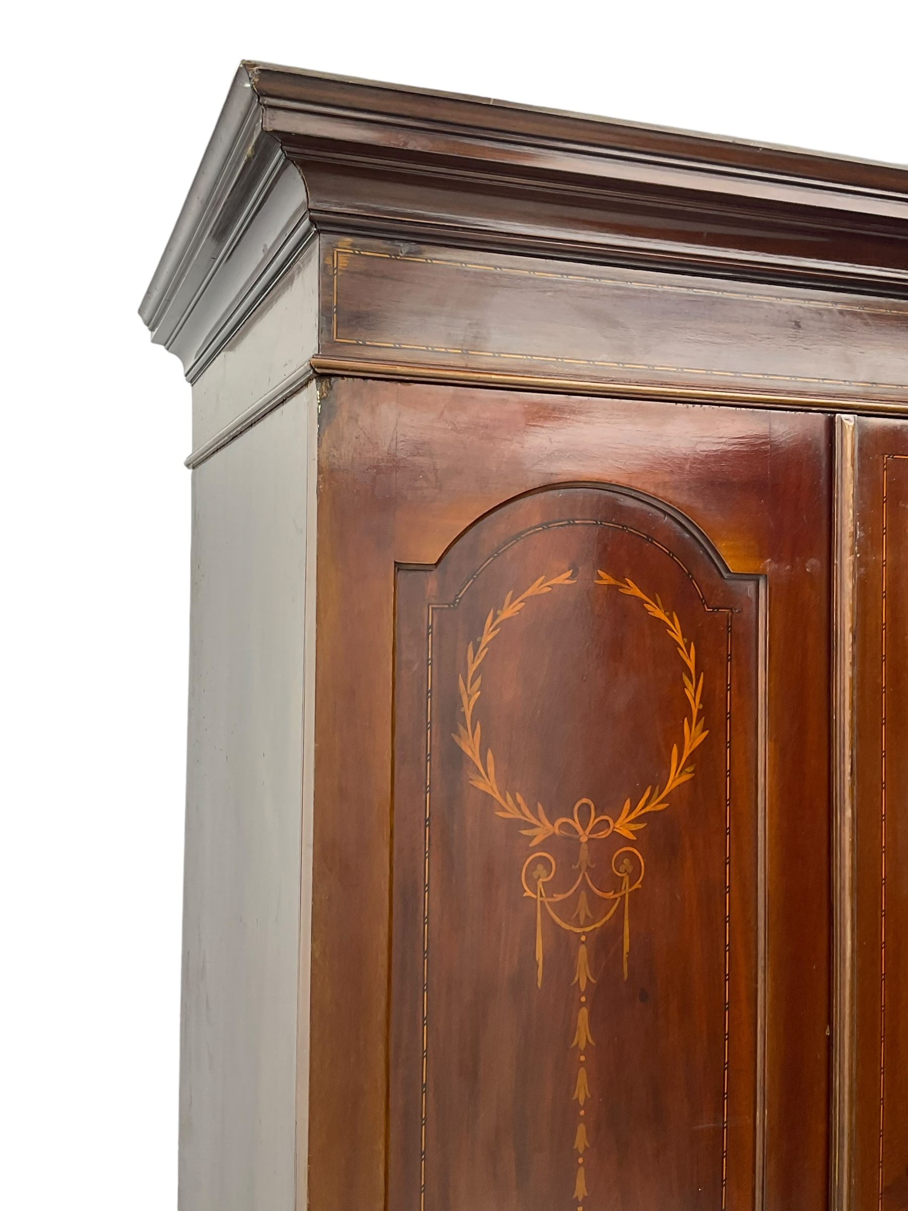 Edwardian inlaid mahogany wardrobe, projecting moulded cornice over central bevelled mirror glazed door, panelled uprights inlaid with trailing bellflowers and foliate decoration, the skirted base fitted with single drawer 