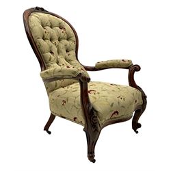 Victorian walnut open armchair, the cresting rail carved with flower heads and foliate motifs, floral carved scrolling supports, upholstered in pale fabric with raised floral decoration