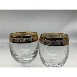 Set of twelve Moser style wine glasses, the bowls with etched floral bodies and gold banded rim with foliate decoration raised upon stem of twisted form, H14cm