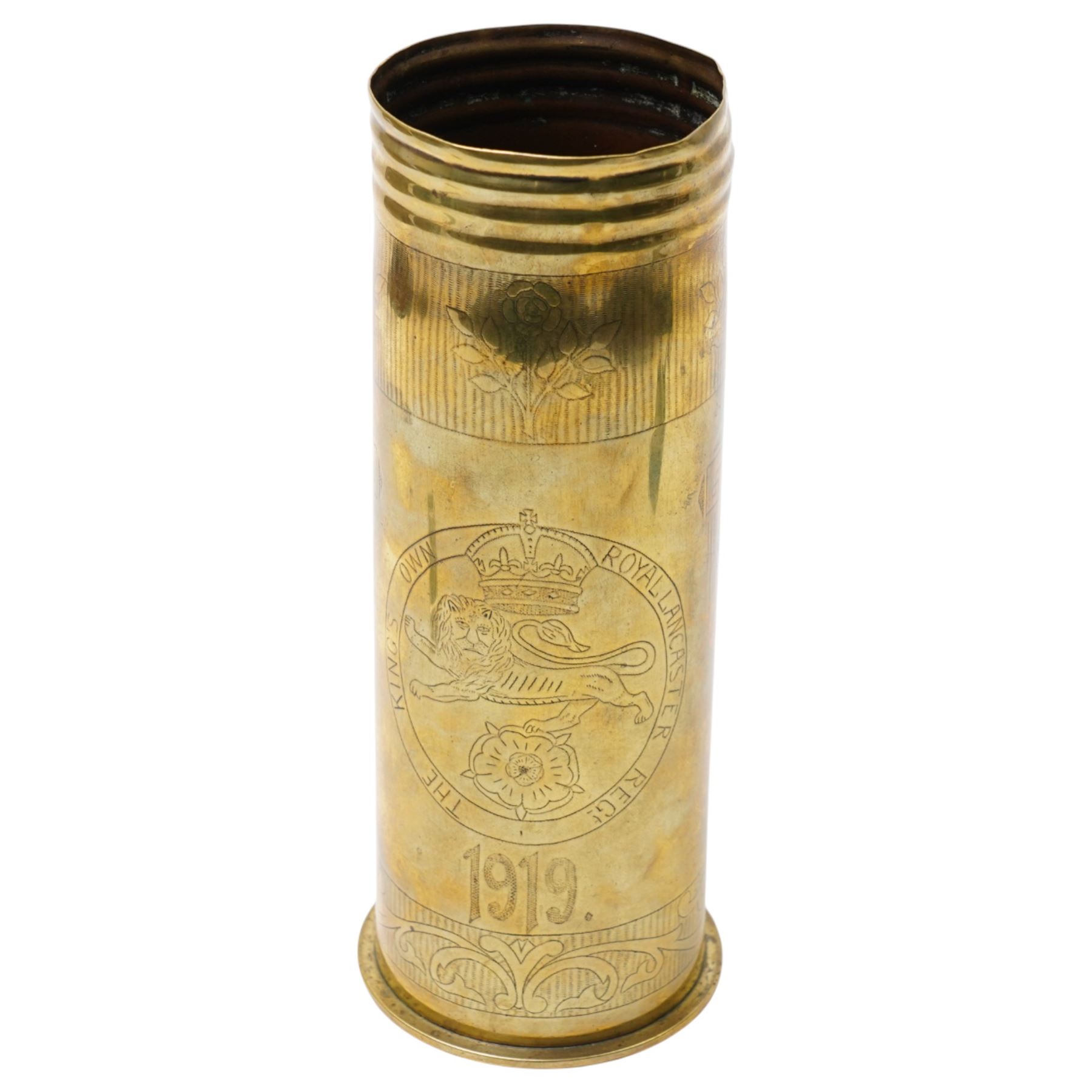 First World War trench art shell casing, decorated with crest for The Kings Own Royal Lancaster Regiment, one side decorated with detailed portrait; together with Two Victorian Brass finger plates together with a brass badger and a saussurite model of a pig