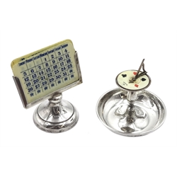 Edwardian silver bridge trumps marker, in the form of a garden sundial with bowl base and ivorine dial by Britton, Gould & Co, Birmingham 1907 and a silver desk calendar with ivorine date panels by Sydney & Co, Birmingham 1919