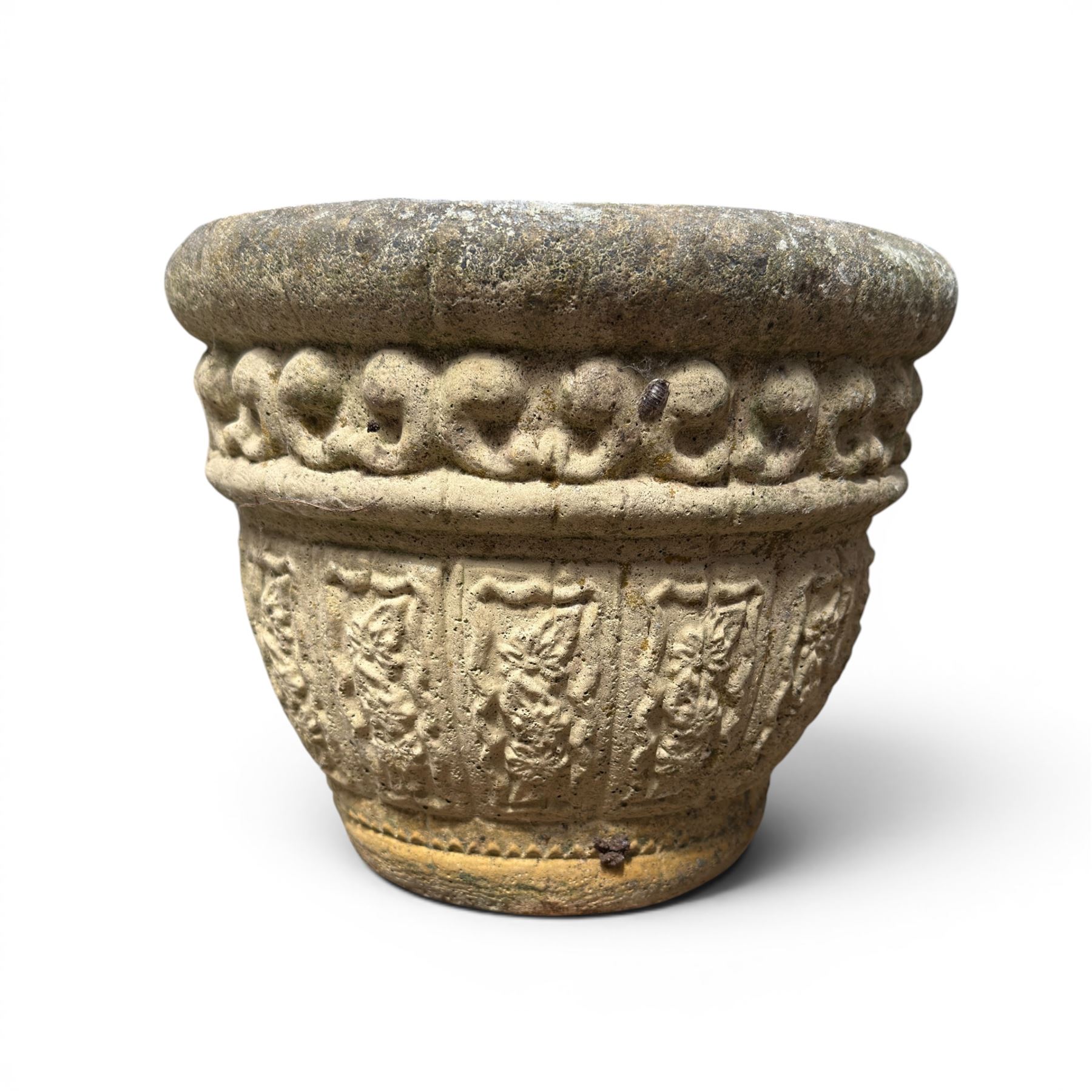 Set of three cast stone planters, circular form with C-scroll design frieze over a floral decorated body, weathered finish