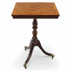 Early 20th century walnut chess table, square checkered veneered top with crossbanded edge, raise on a turned column based with acanthus craving, on three outswept legs terminating in brass paw caps above castors
