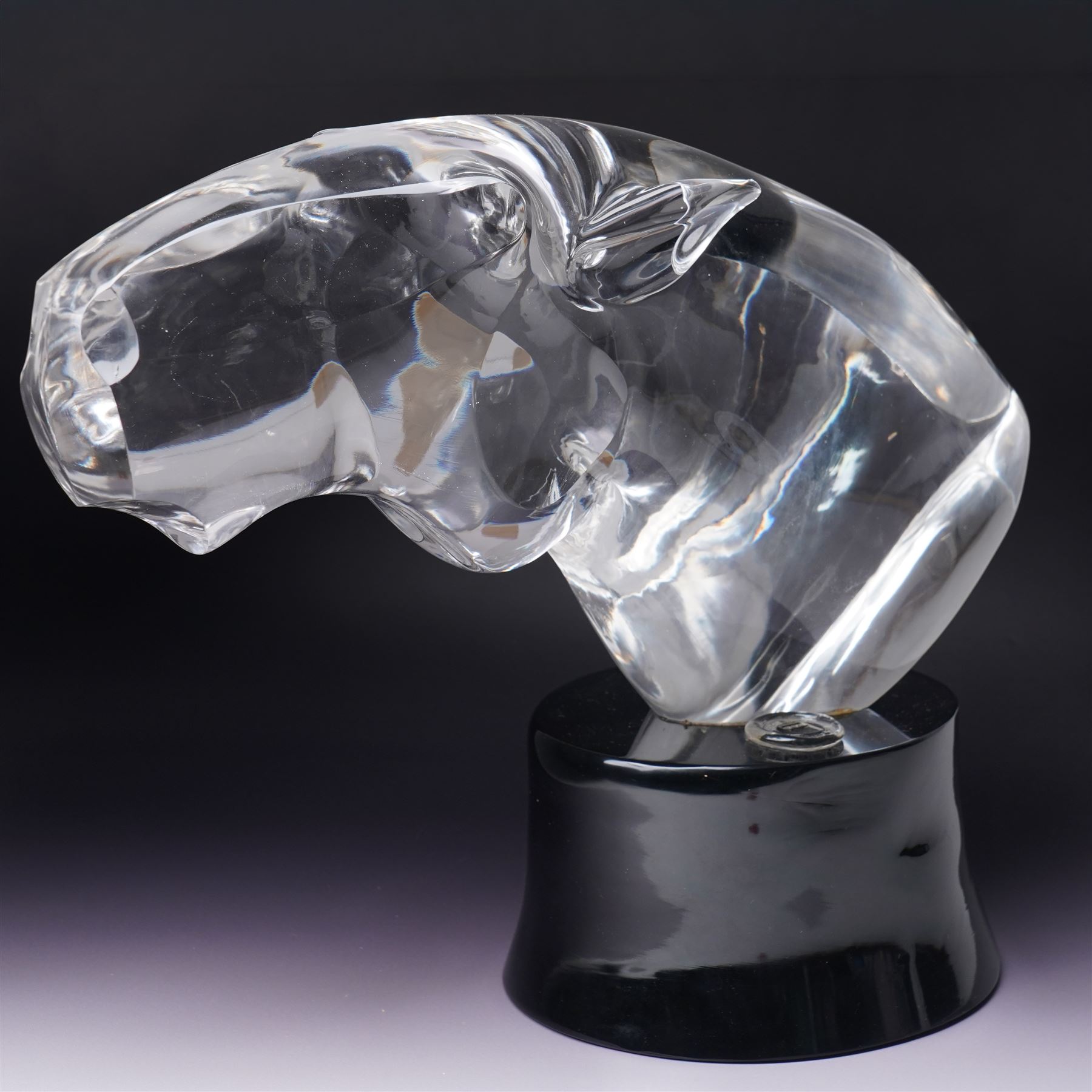 Loredano Rosin (Italian 1936-1992): Horse's Head, clear cut glass sculpture mounted on an oval plinth of black glass with incised signature, with impressed makers medallion, overall H35cm W47cm 
Notes: Rosin was widely exhibited Murano glassmaker who collaborated with artists such as Picasso and Chagall, this piece probably dates from the 1960s. 