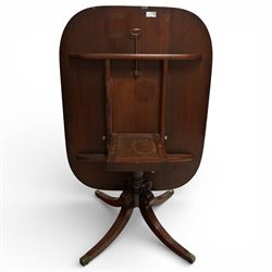 Regency figured mahogany breakfast table, figured rectangular tilt-top with rounded corners and rosewood banding, on turned column with four out-splayed supports with brass cups and castors 