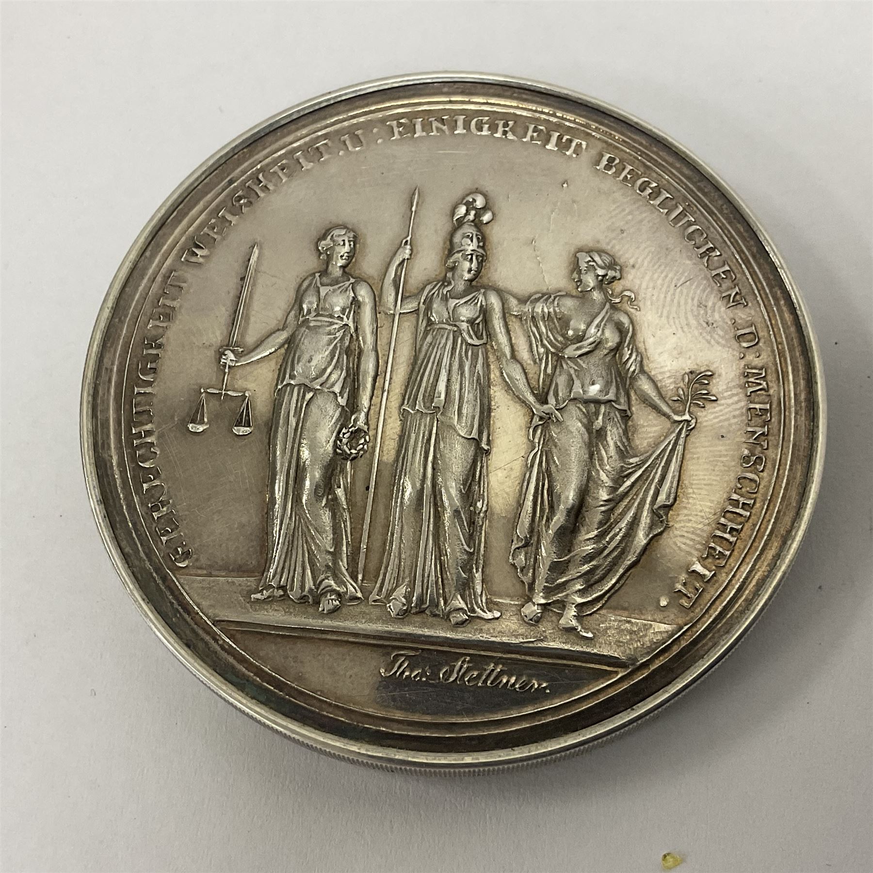 Grolier Club’s silver Schraubmedaille to commemorate the German campaign of 1813, obverse depicts a Greek temple, below “Eintracht Überwindet Alles”, the reverse depicts three figures and the text “Gerechtigkeit. Weisheit. U. Einigkeit. Beglücken. D.: Menschheit”, inside are twelve circular hand coloured engravings depicting six major battles of the German campaign, each with corresponding descriptions, D