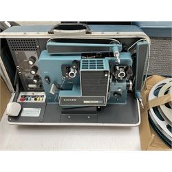 Kodak Carousel S-AV 2020 and 2050 35mm slide projectors, Kodak S-AV cassette recorder 200, Kodak S-AV programmable dissolve control, two Kodak slide carousels and a metal stand; a Singer Graflex 16 cine projector, two 16mm Charlie Chaplin film reels with sound 'Between Showers' and 'Oh What a Night', and five film spools; freestanding roll-up projection screen, and a wood framed reflective daylight projection screen