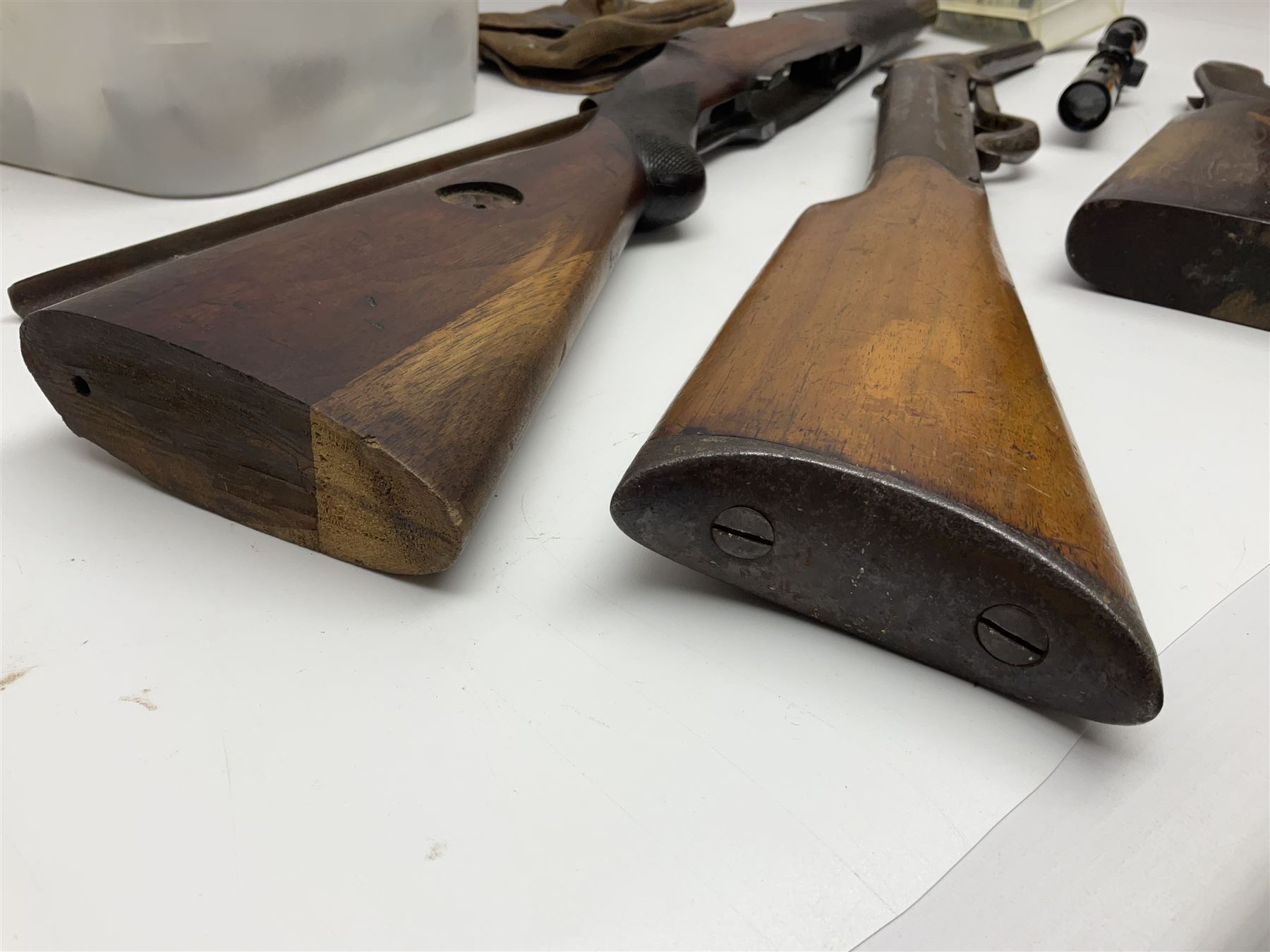 Assorted rifle and pistol spares; early Gem air rifle with sawn off barrel (piece present); telescopic sight; canvas/leather ammunition pouch; Mauser stock; barrel browning solution etc