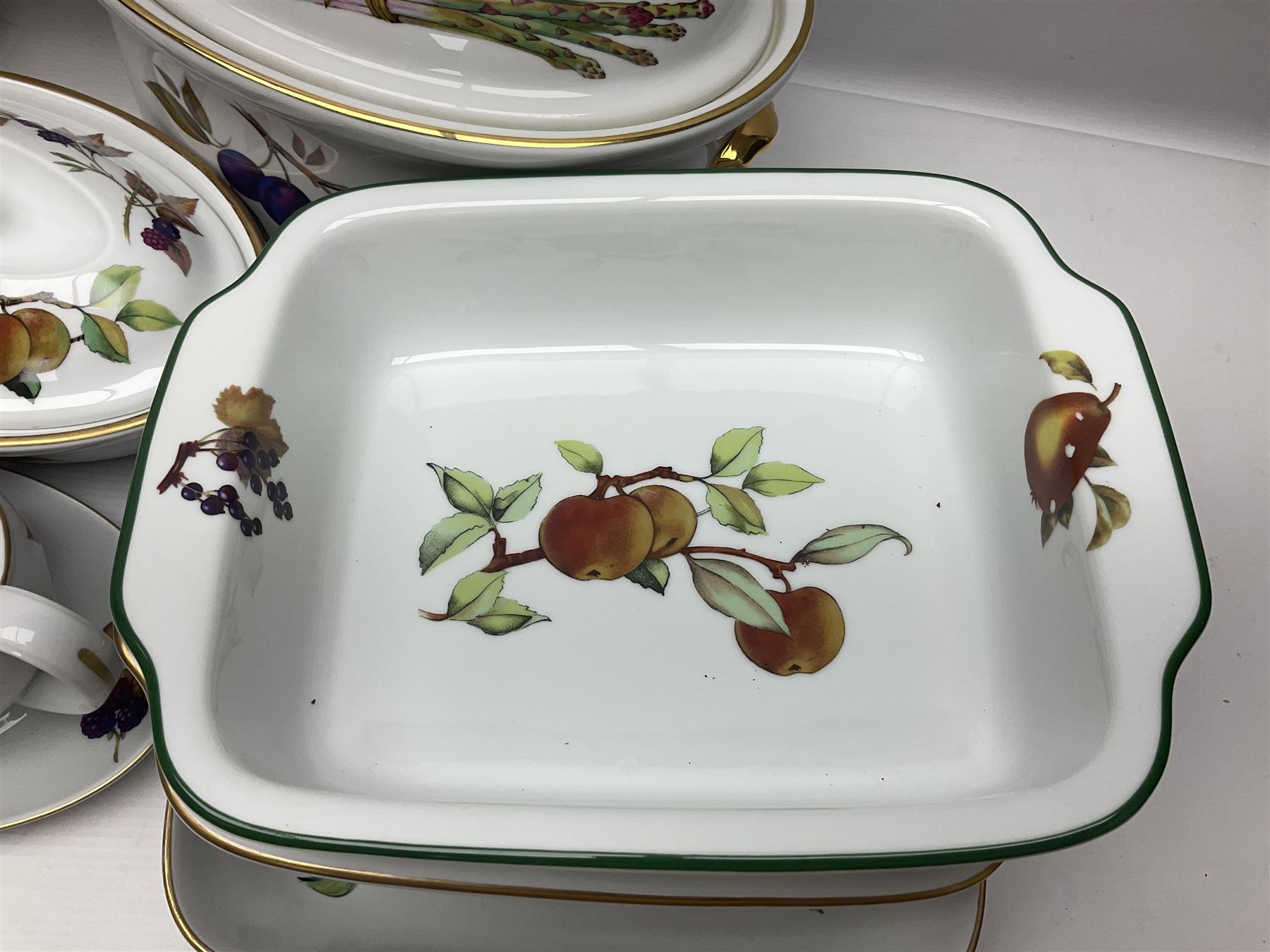 Royal Worcester Evesham pattern, including covered pot de cremes, twin handle tureen, serving dishes, flan dishes, side plates etc  