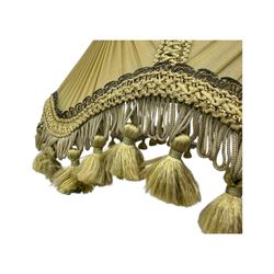 Early 20th century floor lamp, with fringed and pleated silk shade over a carved and turned column, on a circular stepped base