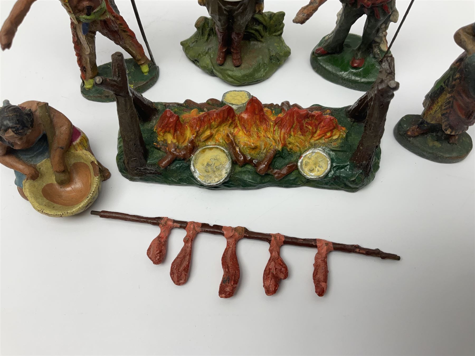 Five Elastolin American Indian figures, together with an Elastolin campfire and a cowboy tied to a tree, tallest H11cm