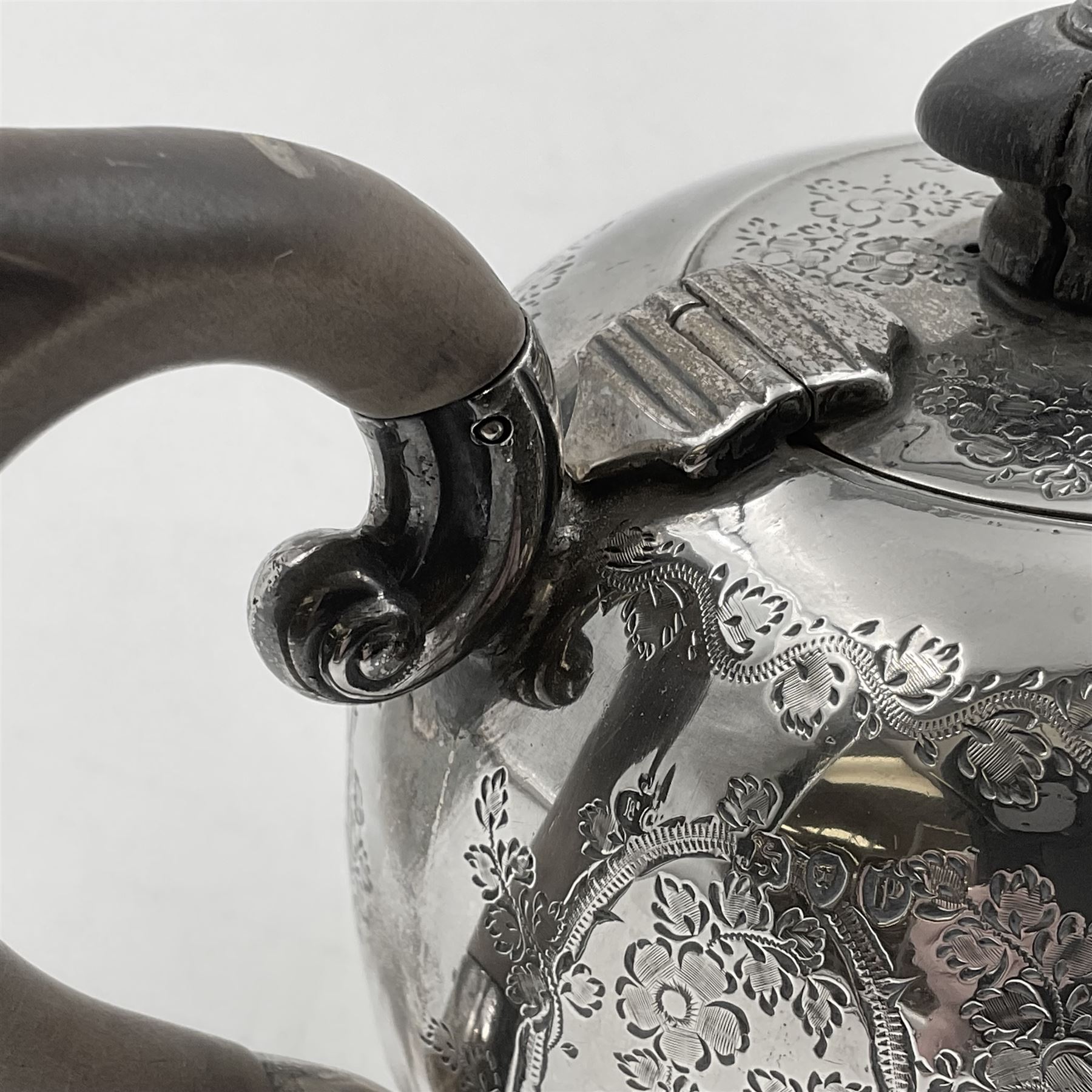 Late Victorian silver bachelors three piece tea service, comprising bullet shaped teapot, open sucrier and milk jug, each engraved with monogram surrounded by birds upon and amidst a blossoming vine, the teapot with scroll capped curved wooden handle and wooden finial to cover, hallmarked Wakely & Wheeler, London 1890, teapot including handle H12cm, sucrier H5.5cm 