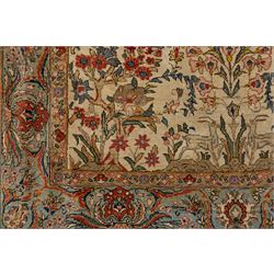 Persian pictorial Kashan rug, ivory field woven with a central tree of life surrounded by flowering plants, birds, and animals, enclosed by a broad turquoise border with scrolling foliage and palmettes
