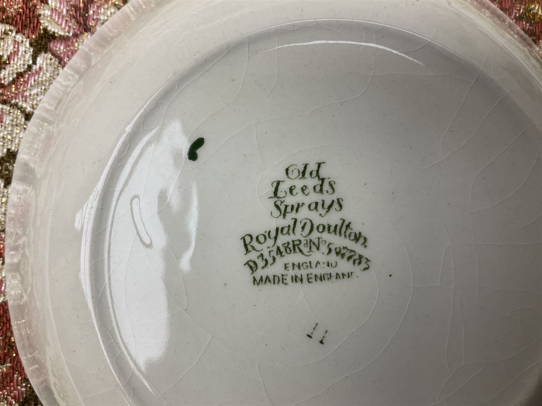 Royal Doulton part dinner service in Old Leeds Sprays pattern,  to include cheese dome, teapot and stand, egg cups etc, together with a selection of floral doilies.  