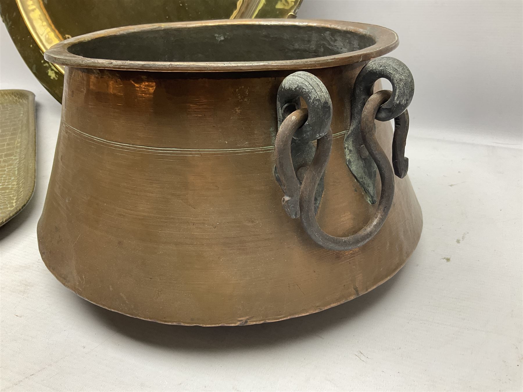 Copper pot with twin iron handles, large heavy planished brass charger and brass crocodile tray, charger D59cm