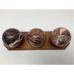 Set of three marble spheres on a elongated octagonal wooden base, H12cm