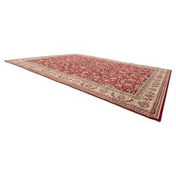 Royal Kashmir worsted wool modern Persian design area rug, with crimson field and stylised rosette patterning throughout, surrounded by wide multi-band border incorporating cartouche and lotus flower motifs