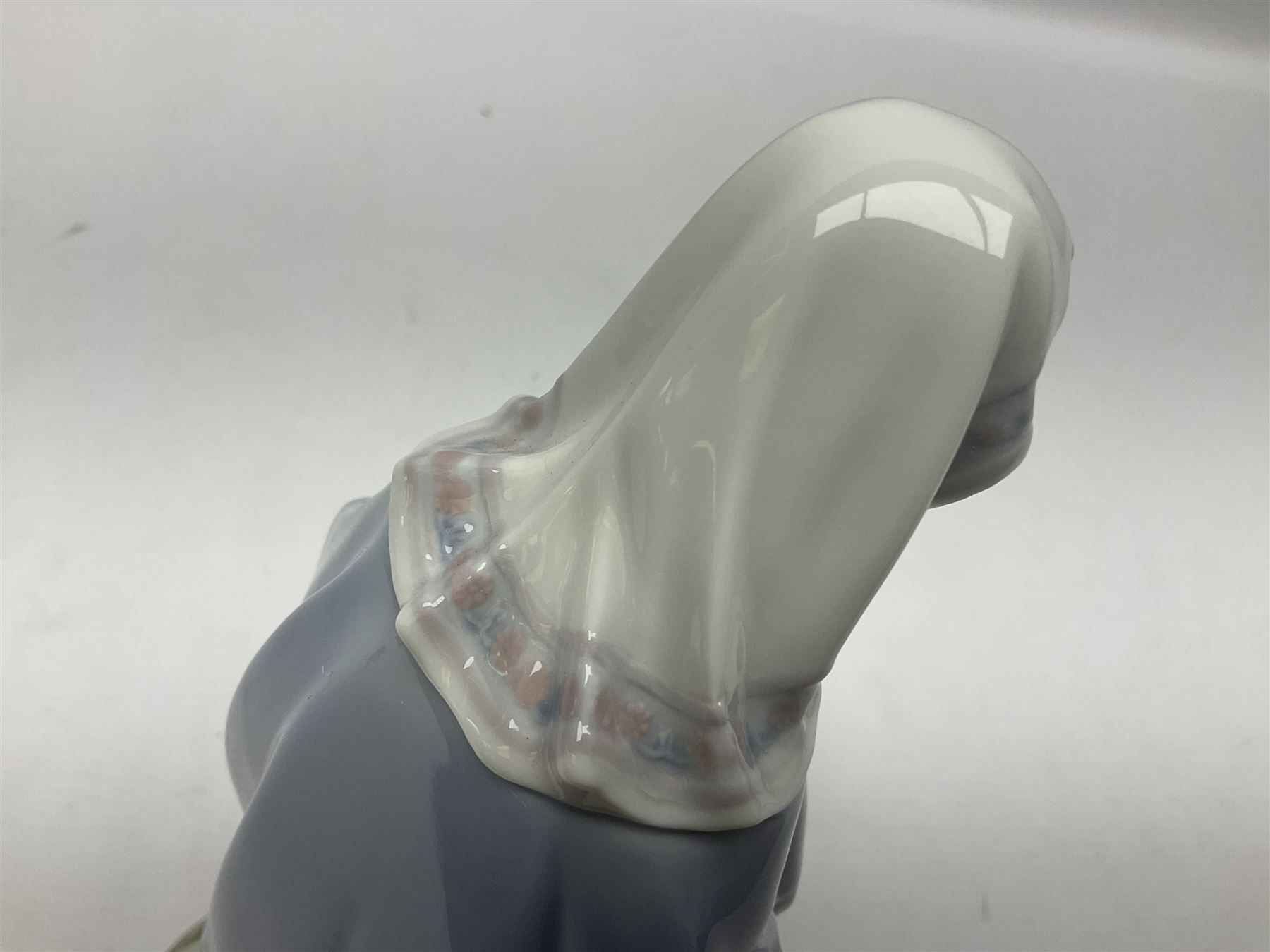 Lladro figure, Holy Night, modelled as Mary kneeling over baby Jesus, sculpted by Vincente Martinez, with original box, no 5796, year issued 1991, year retired 1994, H22cm