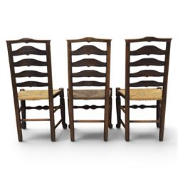 Set of seven (6+1) Georgian design country elm Lancashire dining chairs, ladder backs with rush seats, turned front leg stretcher on pad feet, height of seat 44cm, complete with fitted tie on cushions
