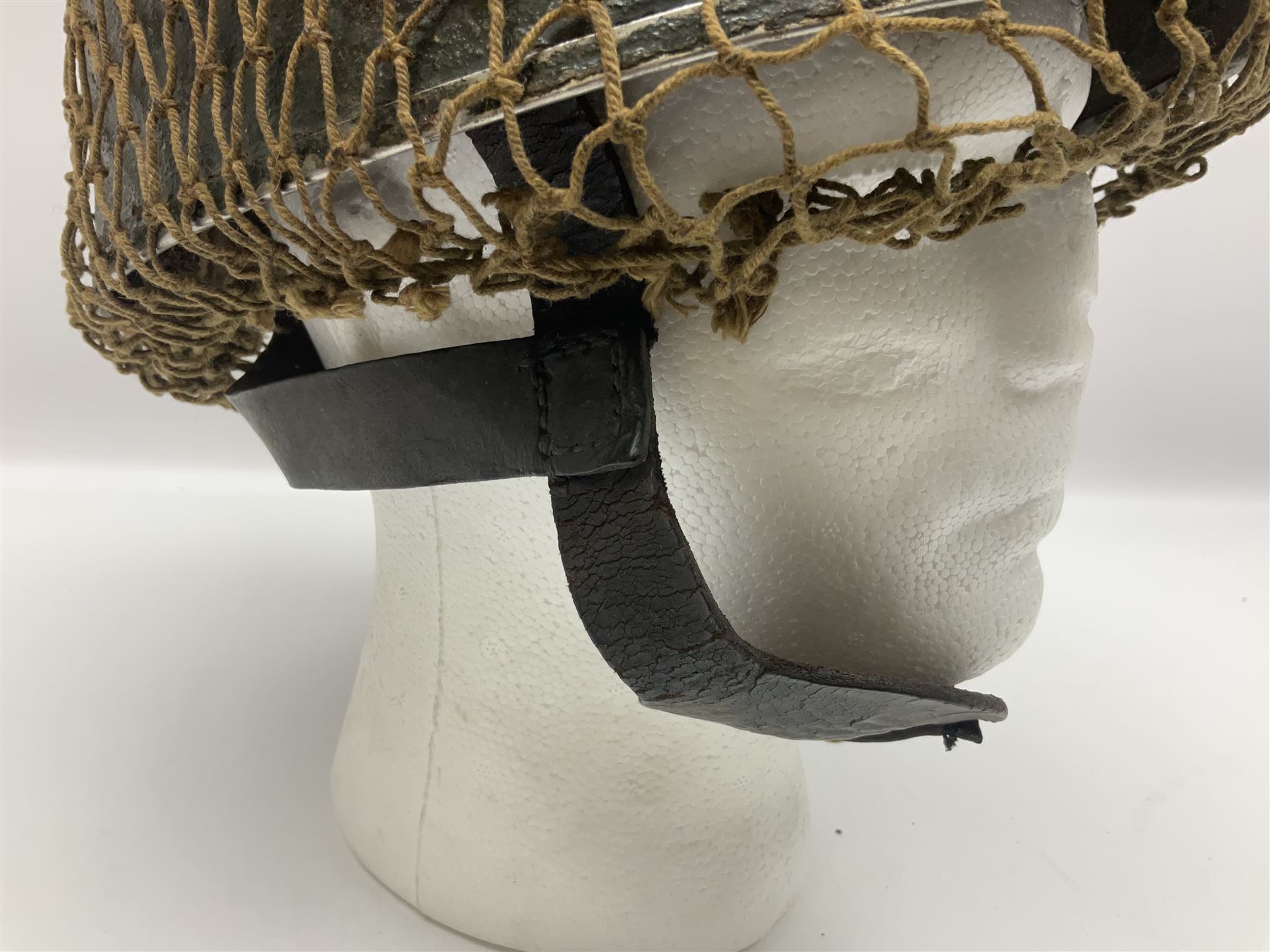 WW2 British Airborne Troops/Paratroopers Steel Helmet with green textured paint finish and netting cover, leather and sponge liner and three point chinstrap mounting; liner marked BMB 1943; together with a paratrooper's maroon beret with metal badge (2)
