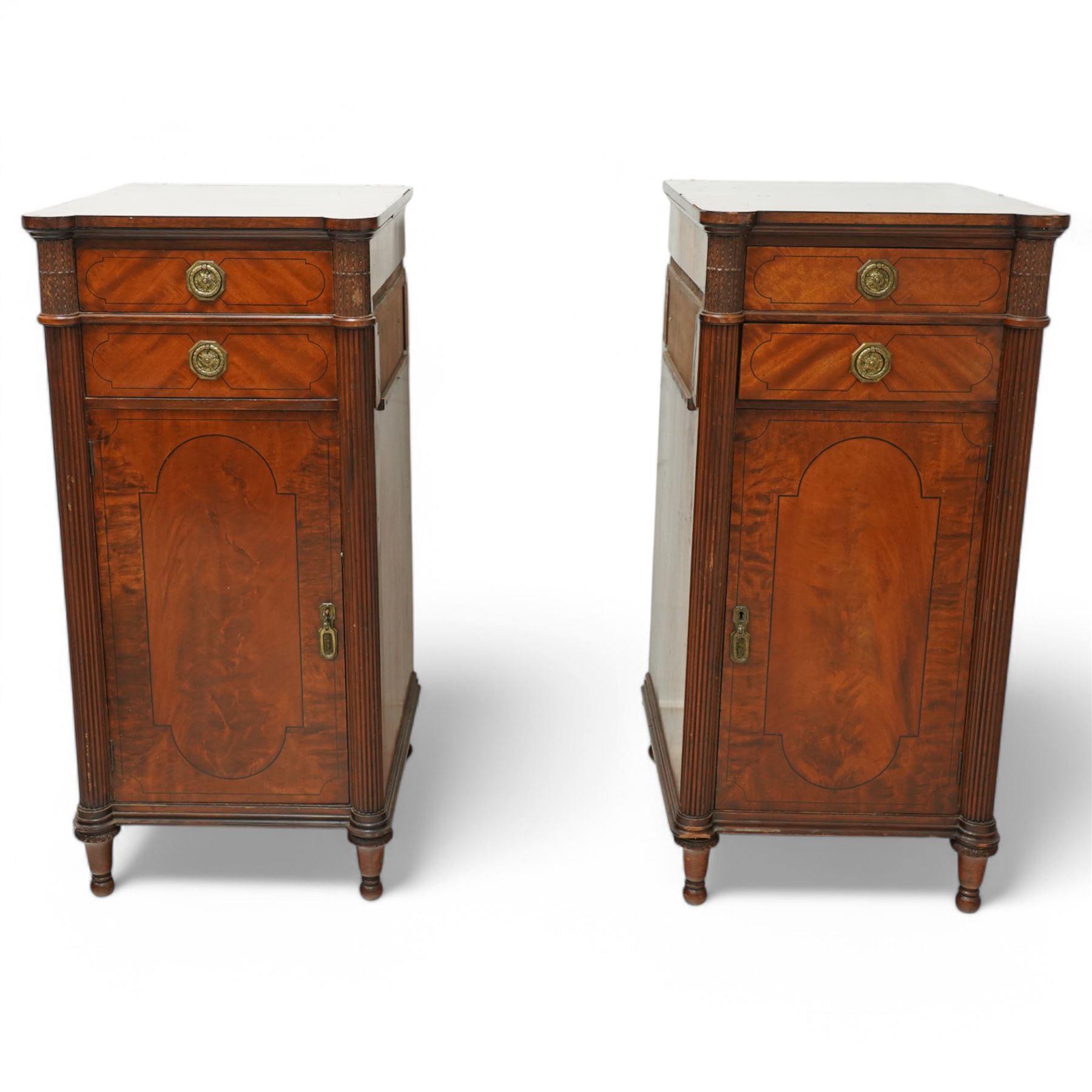 19th century mahogany Hepplewhite design pedestal sideboard or pair of bedside pedestals, each pedestal fitted with two drawers and cupboard, decorated with figured panelled doors and ebony stringing, curled leaf carved mounts over reeded half columns, on turned feet 