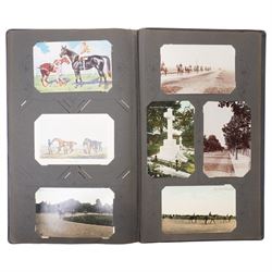 Early 20th century postcard album, belonging to Jockey John Edward (Jack) Leach, born Nov. 1901, with hand coloured pages including twenty two coloured cards from the Jockey Series, silhouette card signed F Winter, other jockey and racing cards, fox hunting, seven Racing Pigeon cards etc (141)