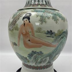 Chinese famille verte vase, of baluster form with fluted rim, the body decorated with five nude female figures amongst water and trees, with bands of polychrome foliate and floral decoration to base and rim, with six character Qianlong mark beneath, upon a circular wooden base, H41.5cm