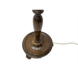 Early 20th century walnut standard lamp, turned column on a circular base with splayed feet, with shade