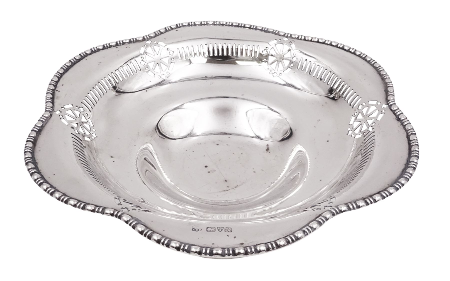 Early 20th century pedestal bowl, of circular form, with lobed bead and dart rim, the sides with pierced wheel, cross and dart decoration, upon spreading circular foot, hallmarked Barker Brothers, Chester 1917