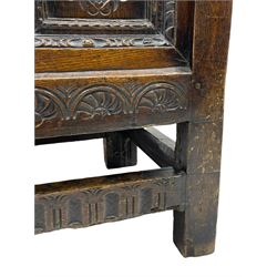 18th century oak coffer, moulded hinged lid over triple panelled front, each panel carved with flower head lozenge, stud work 
