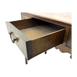 18th century oak lowboy, rectangular moulded top over three frieze drawers with brass swing handles, scalloped apron, on slender square section supports
