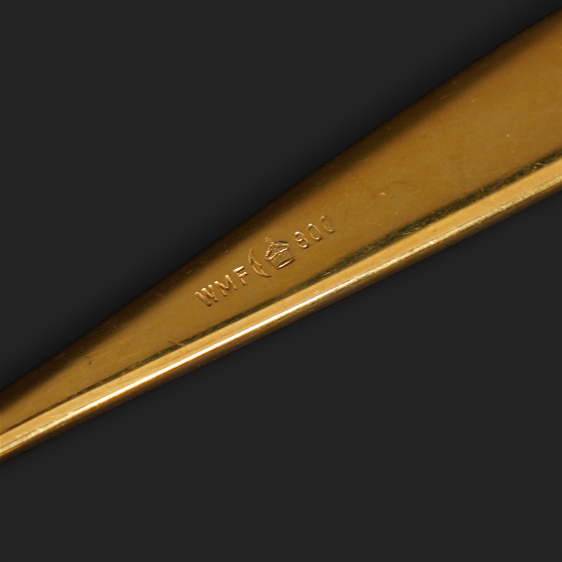 Extensive suite of WMF 800 silver gilt cutlery, for twelve covers, comprising twelve table knives and forks, fish knives and forks, dessert forks, table spoons, dessert spoons, teaspoons, eleven dessert forks and six serving spoons, with crescent moon and crown WMF hallmarks