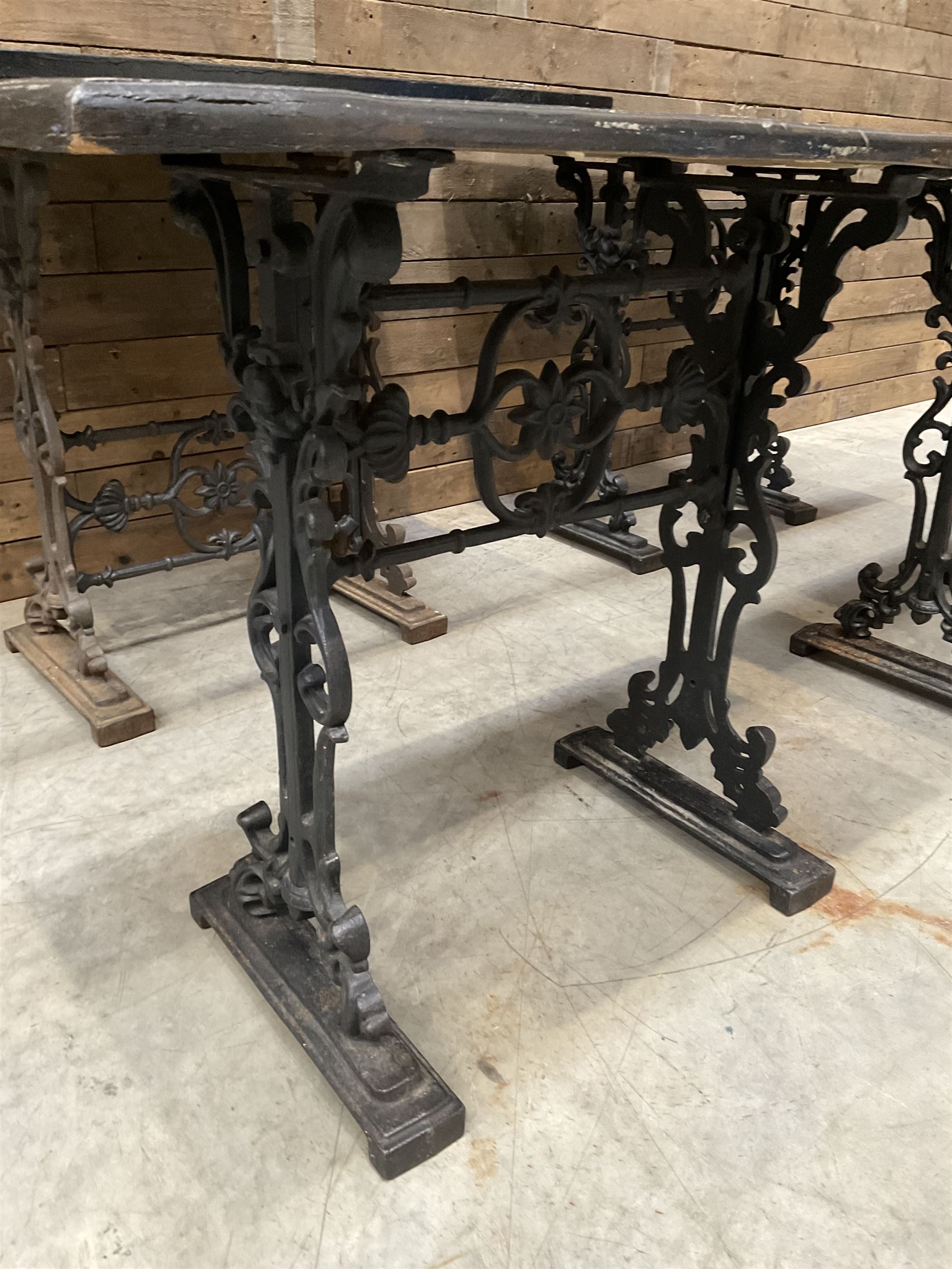 Four cast iron pub or bar tables with rectangular tops