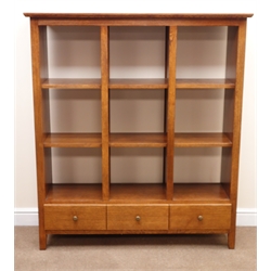  Medium oak open bookcase, nine shelves above three drawers, W127cm, H143cm, D39cm  