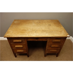  Early 20th century oak kneehole desk fitted with seven drawers, W124cm, H79cm, D75cm  