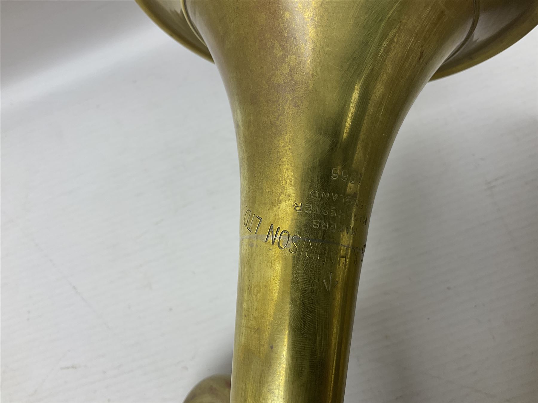 Two military brass bugles by Mayers and Harrison Ltd. Manchester each with crows foot mark and dated 1966; both with multi-coloured cord and tassels, longest 52.5cm (2)
