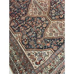 Persian rug, blue ground field decorated with quadruple pole medallion surrounded by animal motifs and stylised flower heads, multiple band border