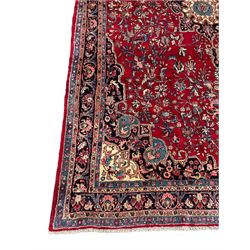North West Persian Bidjar red ground carpet, shaped pole medallion surrounded by interlacing branches and stylised flower heads, five band border with repeating floral design