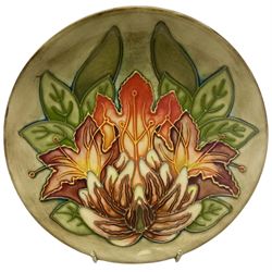 Moorcroft dish, decorated in the Flame of the Forest pattern designed by Philip Gibson, with impressed and painted marks beneath, including date symbol for 1999, D16cm.